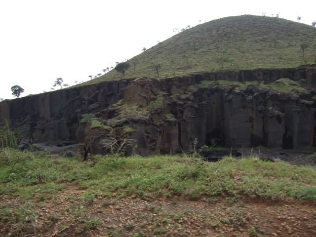 Women work on these cliffs digging out gravel for building blocks